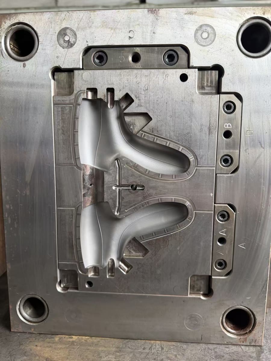 Cavity side of the custom injection mold for an ultrasonic surgical handle shell
